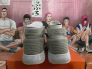 Rear view of light gray high-top sneakers with ribbed white soles