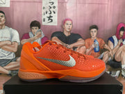 Side view of an orange Nike sneaker showing the textured upper, silver Swoosh, laces, and Zoom-marked midsole.