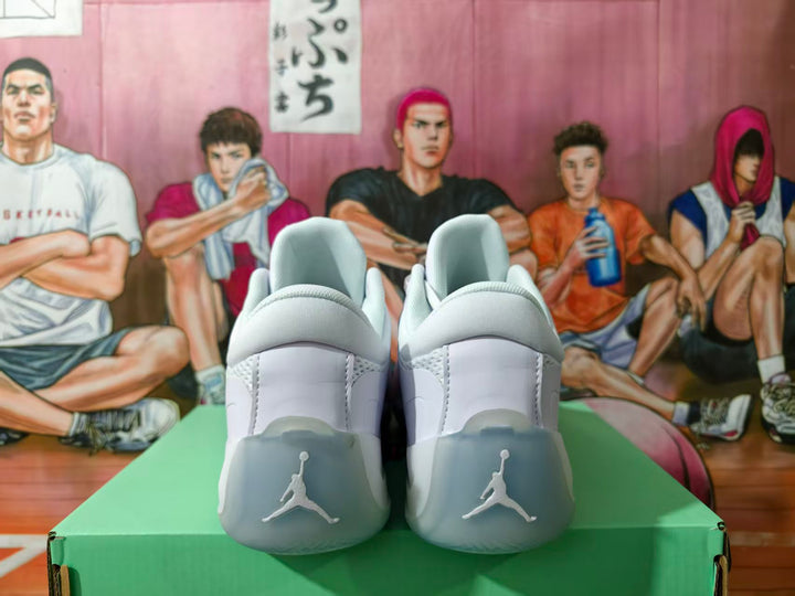 Rear view of white Jordan sneakers showing padded collars, heel branding, and translucent-looking heel sections.