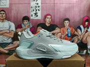 Side profile of a gray Nike sneaker showing the layered upper, Swoosh branding, and sculpted sole.