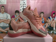 Angled view of the pink sneakers showing the side panels, padded collar, sculpted midsole, and rubber outsole.