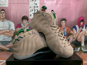 Angled view showing the sculpted side panels, beige upper, green and blue accents, and translucent-looking outsole.