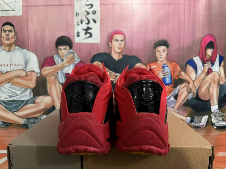 Rear view of red and black Nike basketball shoes with glossy black heel details