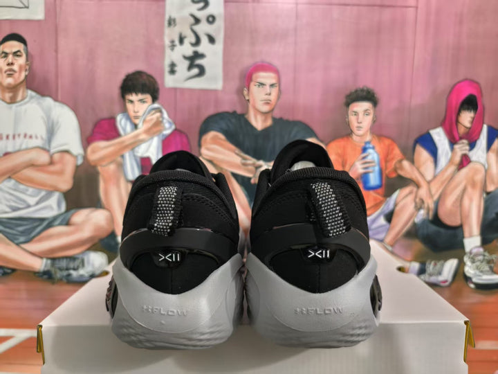 Rear view of black and gray basketball sneakers showing the heel, pull tabs, and contrasting gray heel sections.