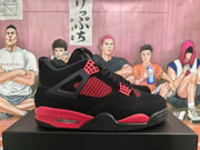 Side profile of a black and red Jordan 4-style sneaker with mesh panels and a visible Air unit.