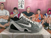 Side profile of a basketball sneaker with a contrasting Swoosh, speckled white overlay, black panel, and grey outsole.
