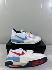 Angled view of the pair highlighting the blue and red Swoosh color contrast, patterned heel and outsole.