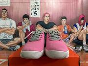 Front view showing the pink uppers, grey laces and white outsoles of Nike sneakers.