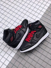 Pair of black and red high-top sneakers displayed together.