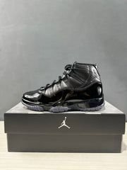 Side profile of a black high-top sneaker with black laces, Jordan upper branding, and a glossy lower section.