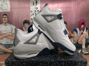Angled view of the pair showing white uppers, speckled grey overlays, dark blue accents and layered rubber outsoles.