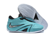 Turquoise Nike sneaker beside a view of its white geometric-tread outsole.