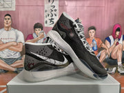 Two black and white Nike basketball sneakers shown from angled side and outsole views.