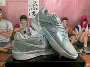 Angled side view showing the Nike Swoosh, layered side panels, pale blue details, and white midsole.