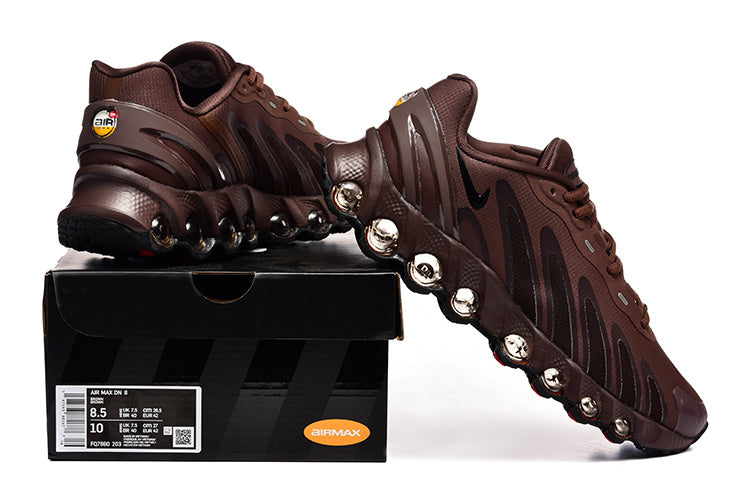 Brown Nike Air Max DN8 sneakers displayed with a shoe box; the box label shows sample sizes US 8.5 and US 10.