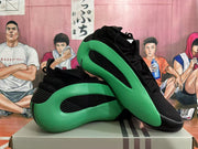 Two black and green sneakers displayed from side and front angles