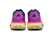 Rear view of the purple and pink adidas shoes, showing the heel logos and yellow-toned soles.