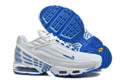 White and blue Nike Air Max Plus III sneakers shown with a view of the blue tread outsole.