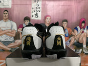 Rear view of the Nike basketball sneakers showing black heel panels, gold embroidered details, and speckled midsoles.