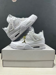 Two white Jordan Air Jordan 4 Net sneakers arranged on a shoebox, with the side supports, outsole edge, and gold-and-black hanging logo detail visible.
