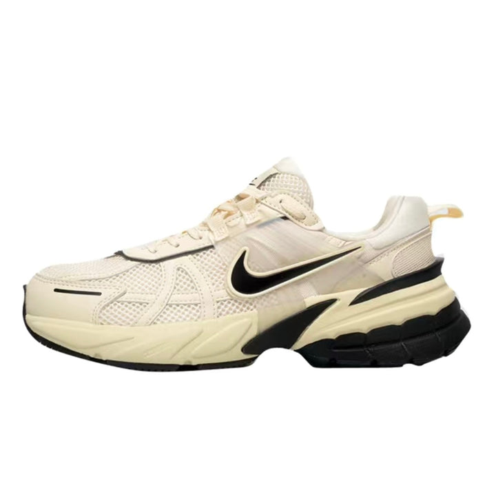 Side view of a cream Nike sneaker with black Swoosh and black-accented sculpted sole