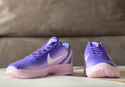 Front view of the pair showing purple laces, tongue branding, violet gradient uppers, and pink outsoles.