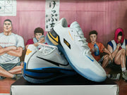 Two white Nike GT basketball shoes showing side and top details with blue and yellow accents