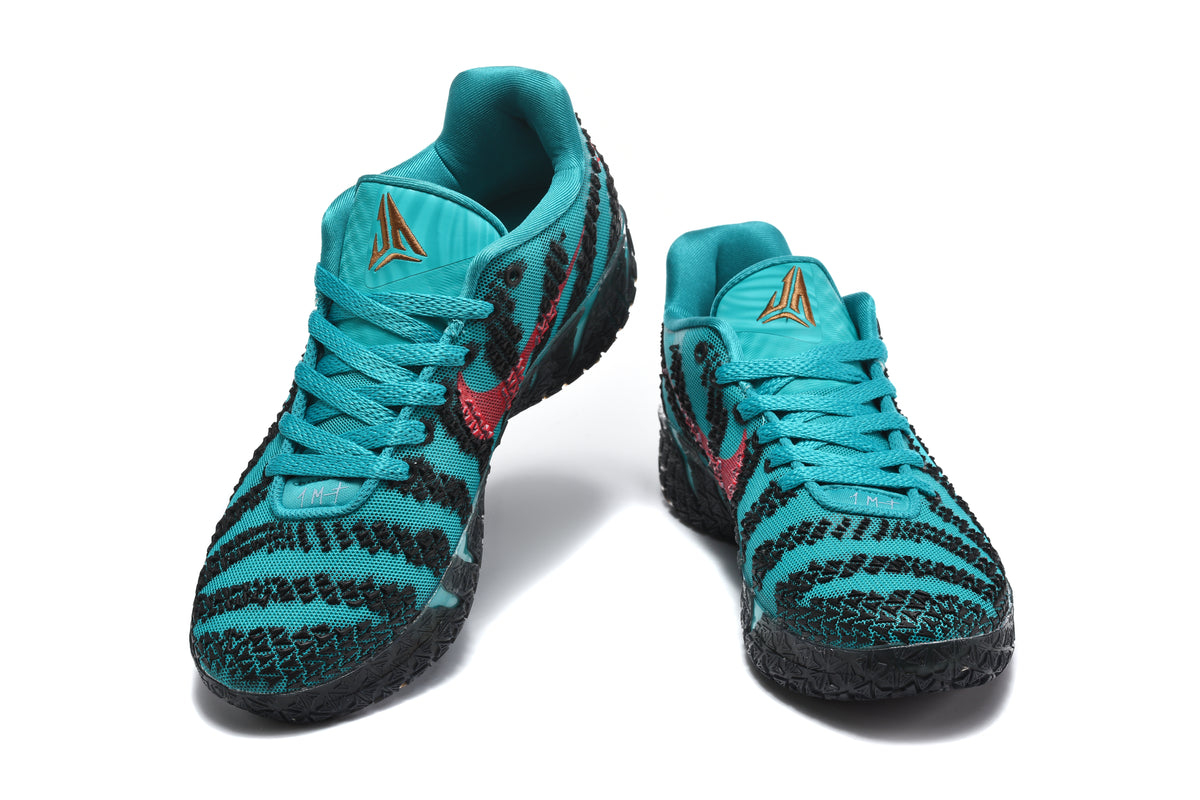 Pair of teal and black basketball sneakers shown from the front with patterned uppers and lace-up closures.