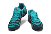Pair of teal and black basketball sneakers shown from the front with patterned uppers and lace-up closures.