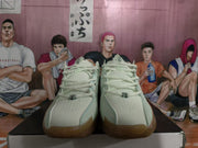 Front view of green Nike basketball sneakers showing cream laces, perforated toe boxes, and translucent gum-colored outsoles.