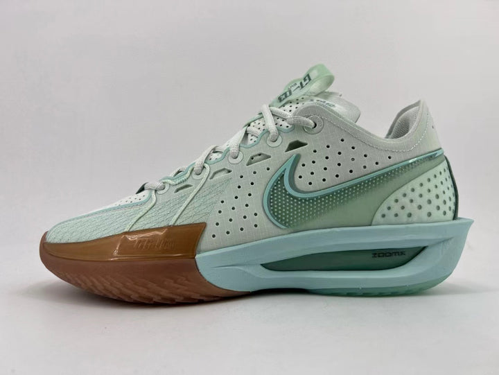 Side view of a pale mint-green Nike basketball shoe with perforated panels, a brown toe and outsole, and a sculpted midsole.