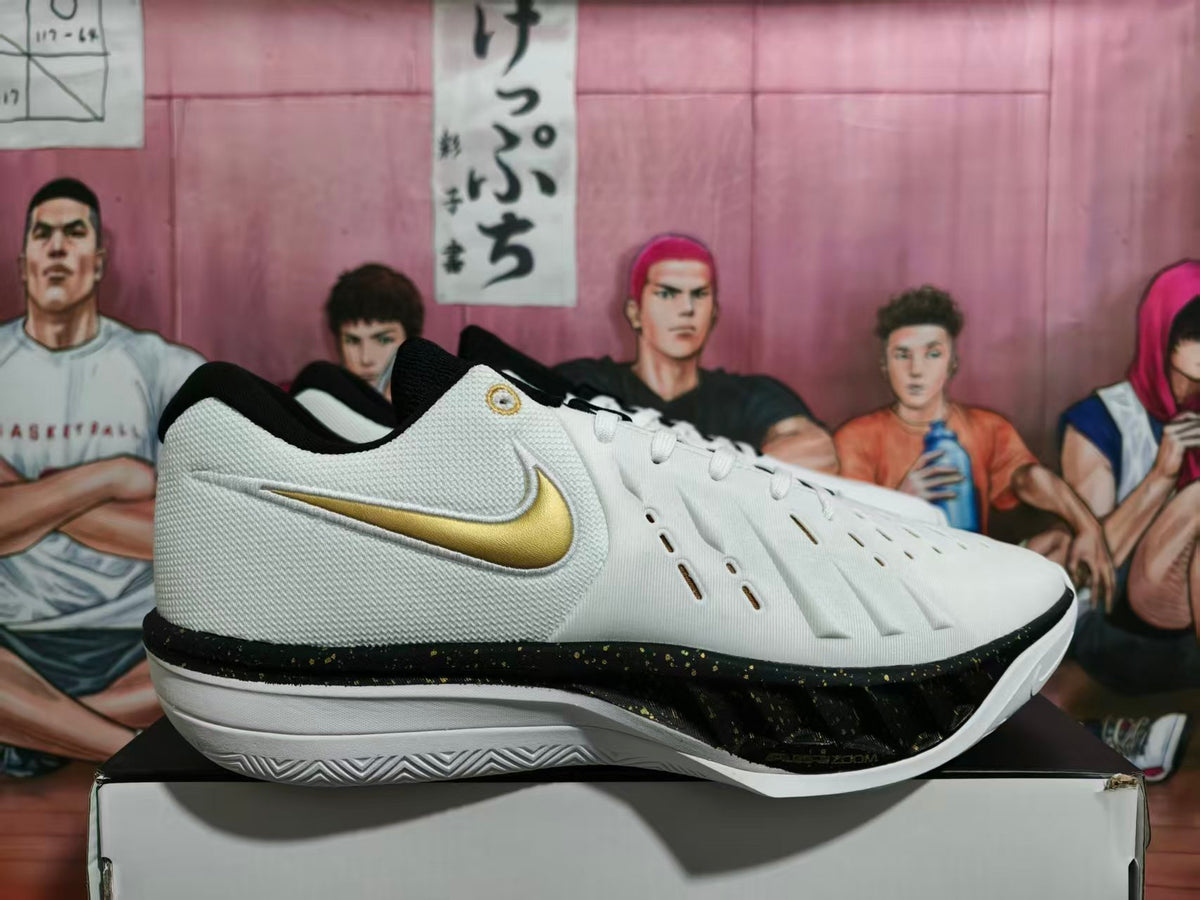 Side view of white Nike LeBron basketball shoes with gold Swoosh and black-and-gold midsole accents.