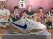 Side view of a white basketball sneaker with a blue Nike swoosh and speckled tan midsole.