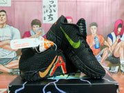 Pair of black LeBron 12 basketball shoes with orange, red, blue, and lime-green details.