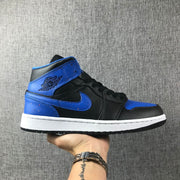 Side profile of a black and blue high-top Jordan sneaker with a white midsole.
