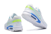 Rear and outsole views of white Nike Air Max sneakers with lime-green heel panels and blue accents.