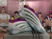 Angled view showing the shoes’ white sides, green accents, and pale aqua outsoles