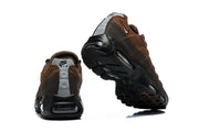 Rear and outsole views of brown Nike Air Max 95 TT sneakers.