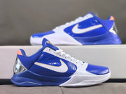 Side view of a Kobe 5 shoe with blue and white panels and gold accents