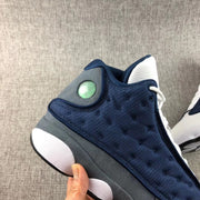Close-up of the navy dimpled side panel and circular heel accent.