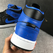 Close-up of the blue heel panel, black collar, stitching, and white midsole.