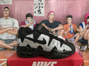 Side view showing silver panels, black Swoosh and black sole