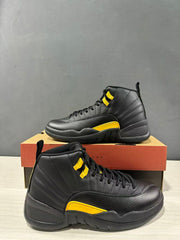 Close side view of two black and yellow Jordan Air Jordan 12 Retro sneakers showing the laces, eyelet accents and raised side detailing.