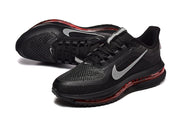 Angled view of black Nike Pegasus Premium shoes with gray Swoosh details and red sole accents.