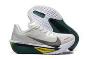 Side and outsole views of white Nike Zoom Fly 6 shoes with dark green, yellow, and gray details.
