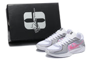 Pair of basketball shoes beside a black box; no readable shoe size label is visible.