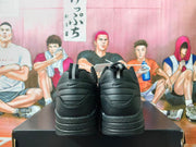 Rear view of black Nike sneakers with layered heel details and pull tabs