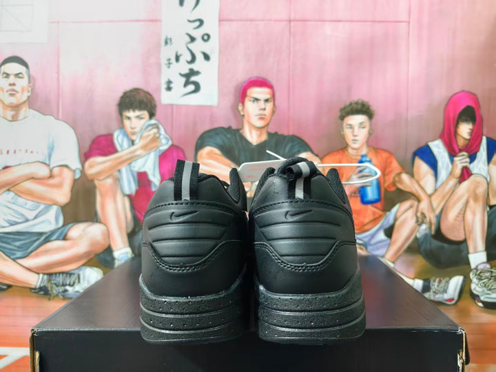 Rear view of black Nike sneakers with layered heel details and pull tabs