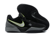 Black sneaker pair displayed with one outsole visible, showing the patterned rubber tread.