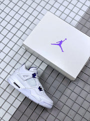 White and purple Air Jordan 4 sneaker beside a white Jordan shoebox.